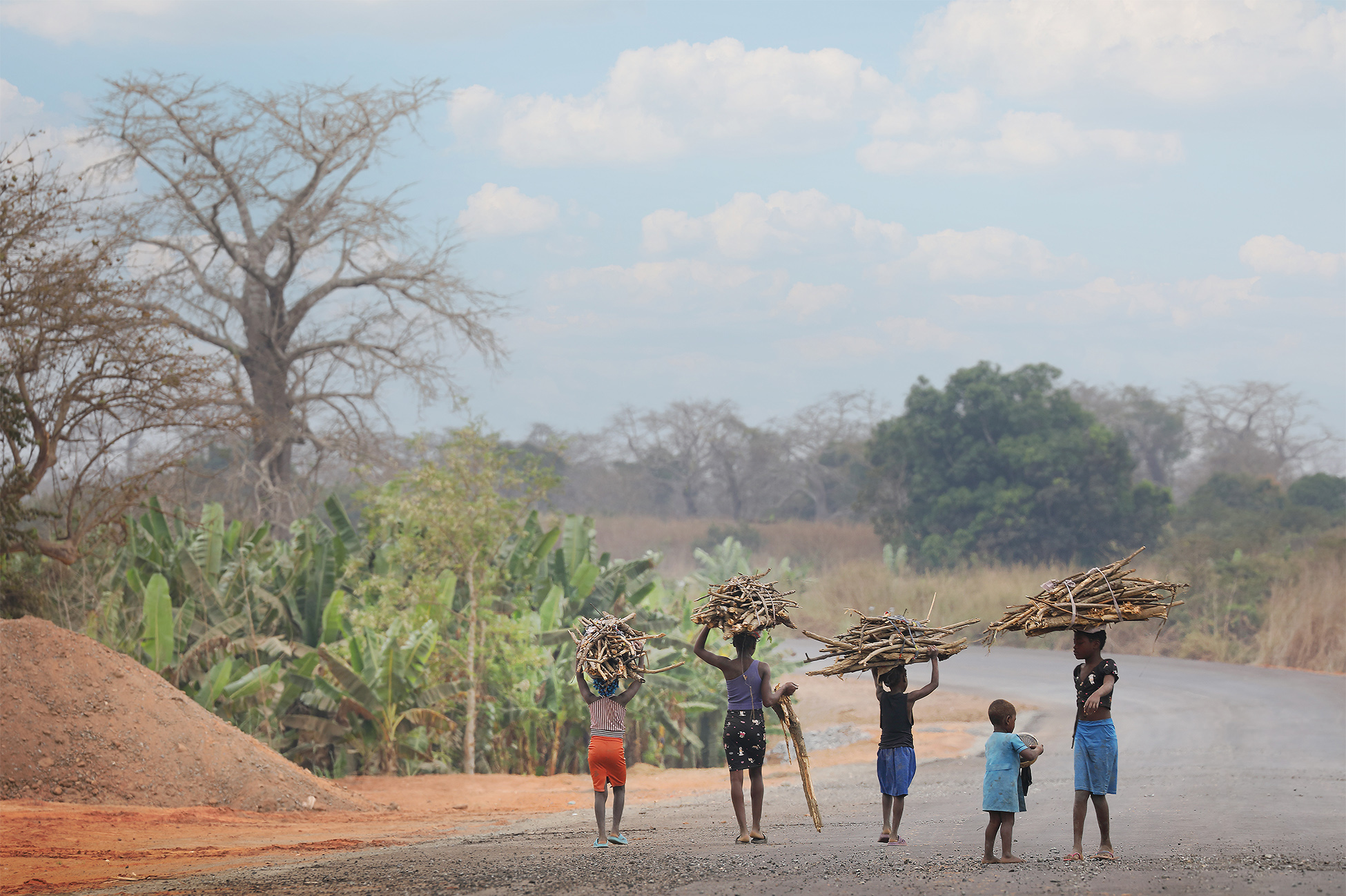 Daily life on the land in Angola is largely shaped by agriculture and rural community activities. Many families grow crops like cassava, maize, and beans, tend livestock, and rely on local markets for trade, while social life revolves around family, communal events, and traditional ceremonies. Usually large distances are undertaken to reach the nearest village and this is done mostly by foot.