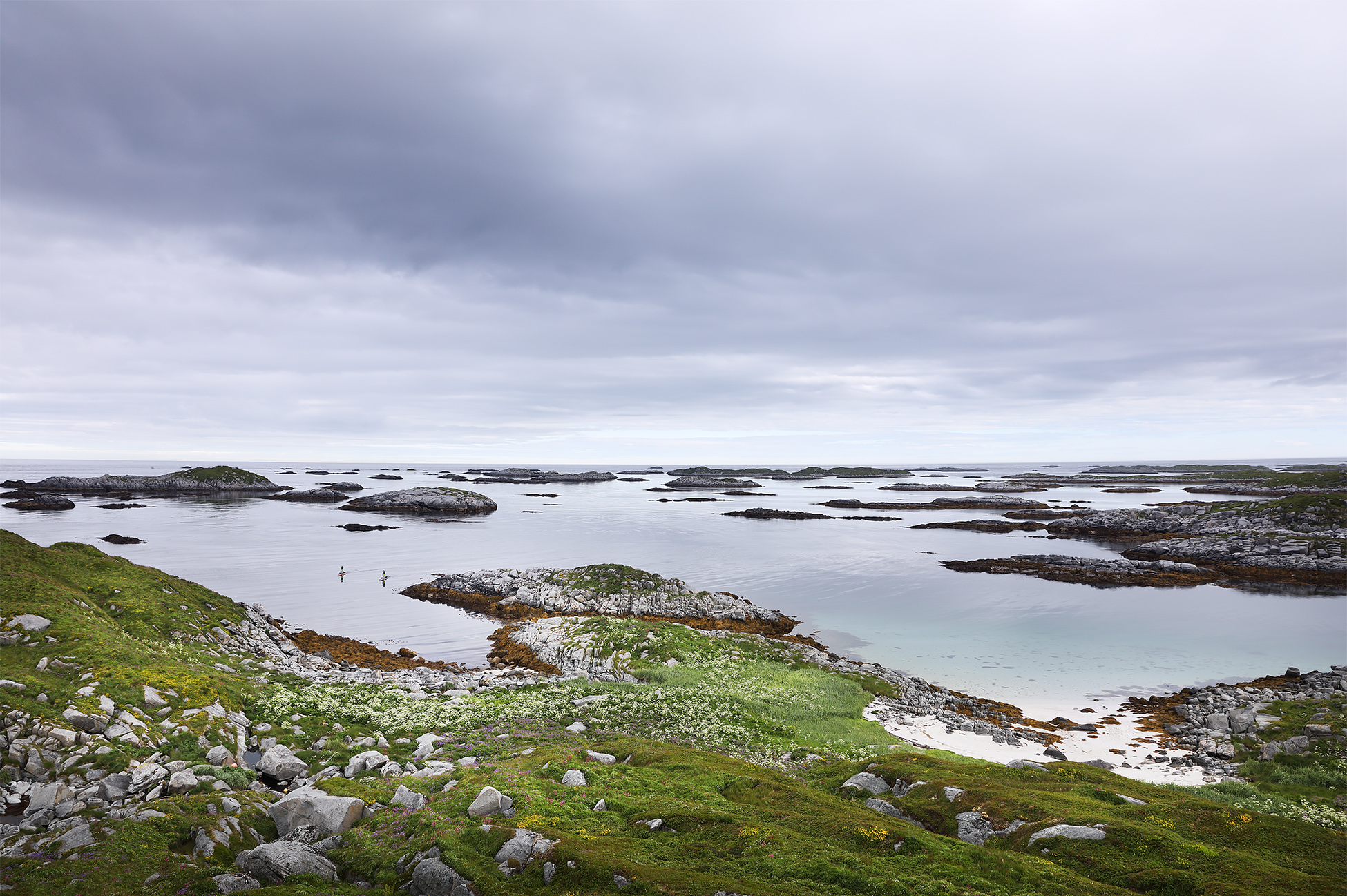 Two lone stand up paddlers navigate the thousands of islands off the coast of Northern Norway