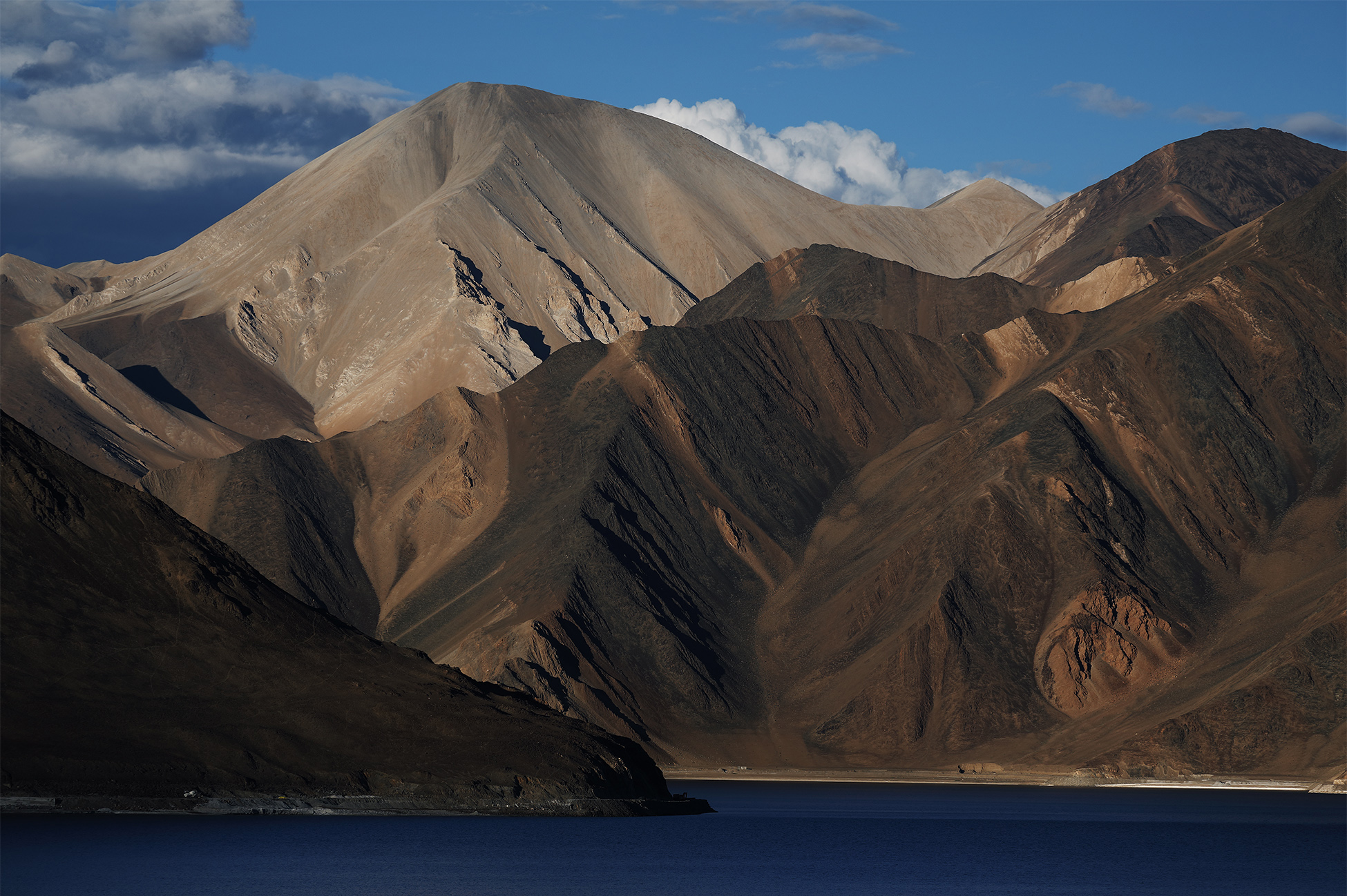 Epic motorbike journey through the rugged high-altitude passes of Ladakh, India.